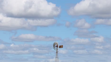 timelapse of clouds passing behind a stationary windmill