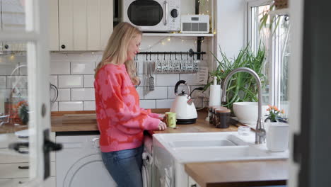 woman pouring tea in kitchen
