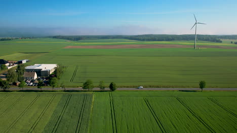 small farm town with windmills in the background