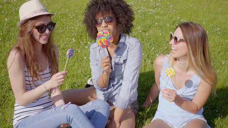 Three-women-licking-lollipops