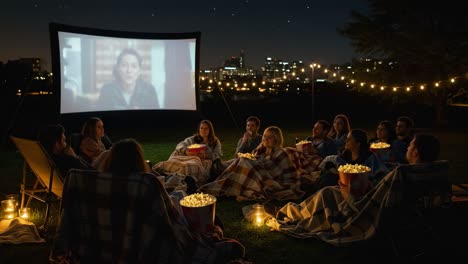 friends enjoying an outdoor movie night under the stars