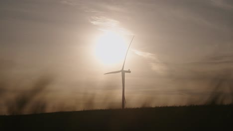 wind turbine silhouette against sunset sky