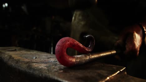 close-up of blacksmith working on a iron rod