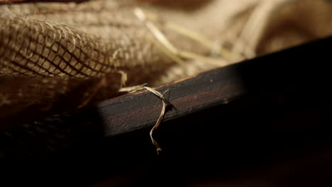 close up of a manger revealing light through burlap