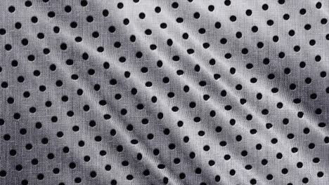 spotted fabric cloth close up shot. black dots on white background, monochrome pattern.