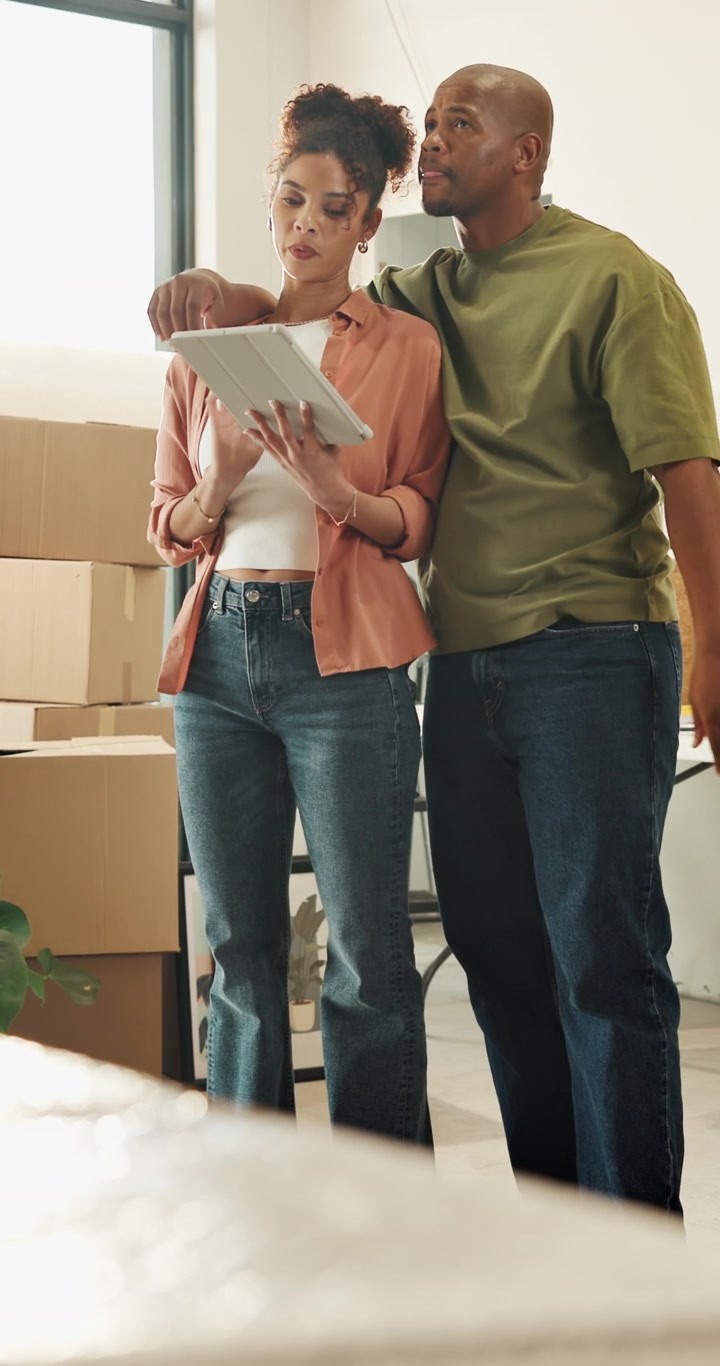 Couple Planning Interior Design in New Home with Moving Boxes
