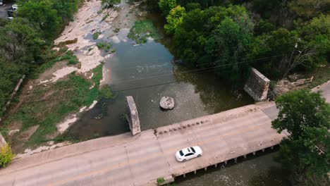 Round-Rock-Memorial-Park-Chisholm-Trail-the-round-rock-and-waterway-aerial-drone-circling-the-round-rock-on-sunny-day-in-4k