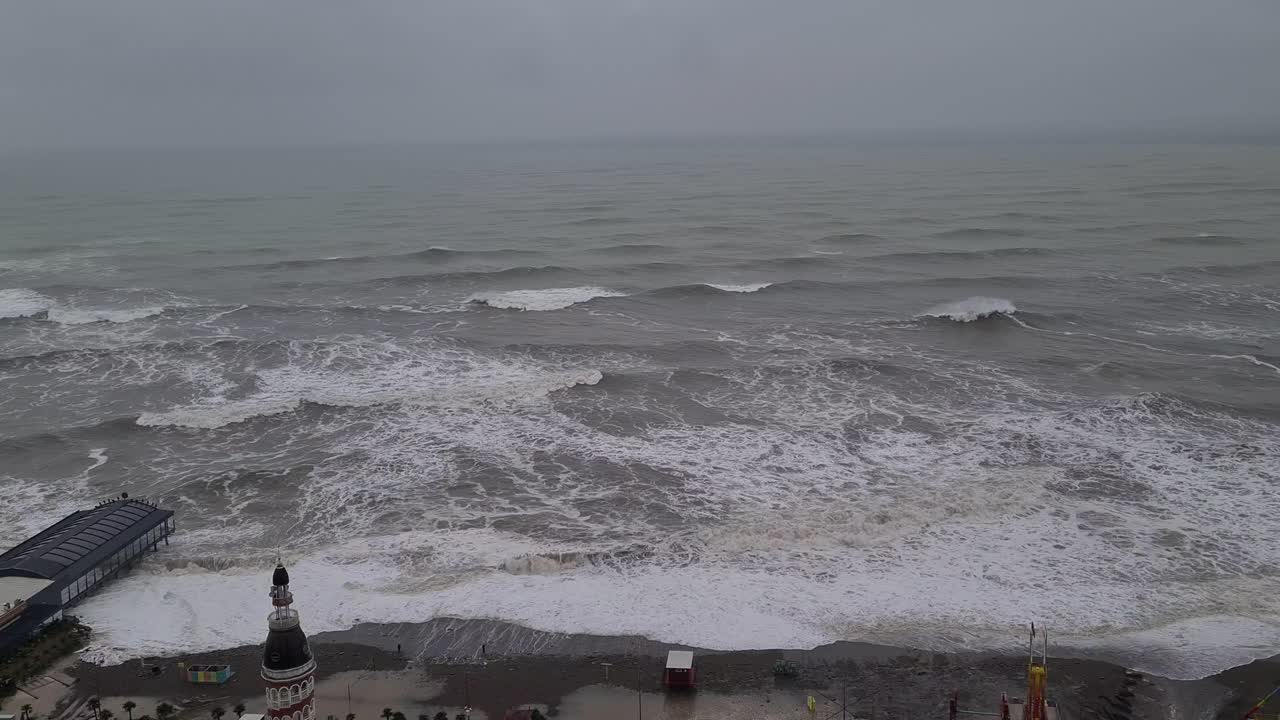 Stormy black sea. big waves destroying shore infrastructure and buildings