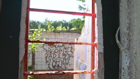 abandoned building interior through a broken window