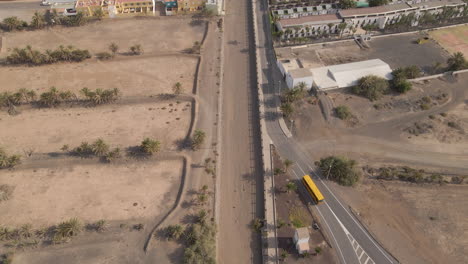 Vista-Aérea-Del-Pueblo-Costero-De-Tarajalejo-Con-Campo-De-Fútbol-Y-Hoteles-En-La-Isla-De-Fuerteventura,-Las-Palmas,-España