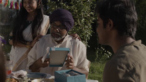 joyful family celebration with gift opening outdoors