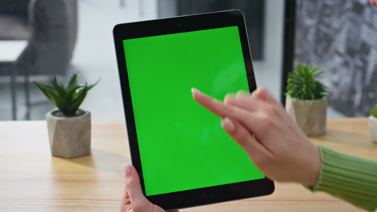 Manager finger using green screen tablet internet surfing on workplace closeup