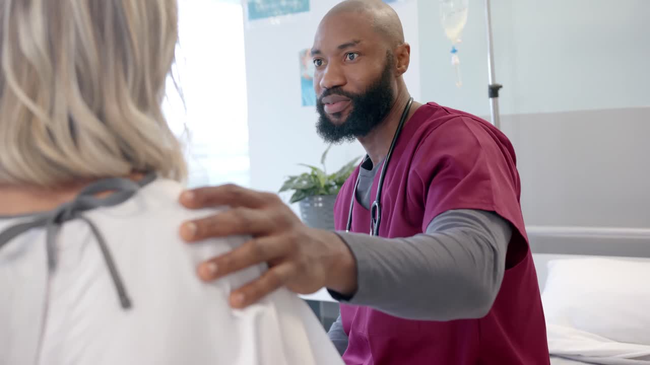 African american male doctor talking to caucasian female patient with prosthetic leg at hospital