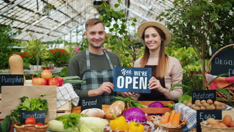 friendly farmers market vendors greet customers