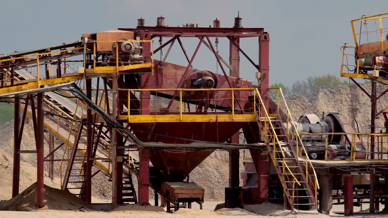 Stone crusher plant machine. Conveyor belt in work process. Transportation and separation of gravel pebbles. Quarry equipment for production of building materials.
