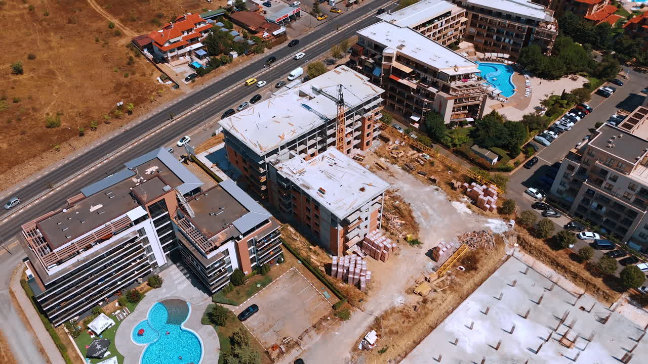 Urban construction project near water. A construction site with cranes and steel elements located close to the sea