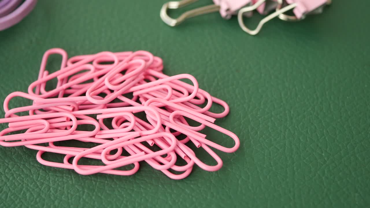 Pink Paperclips on Green Desk