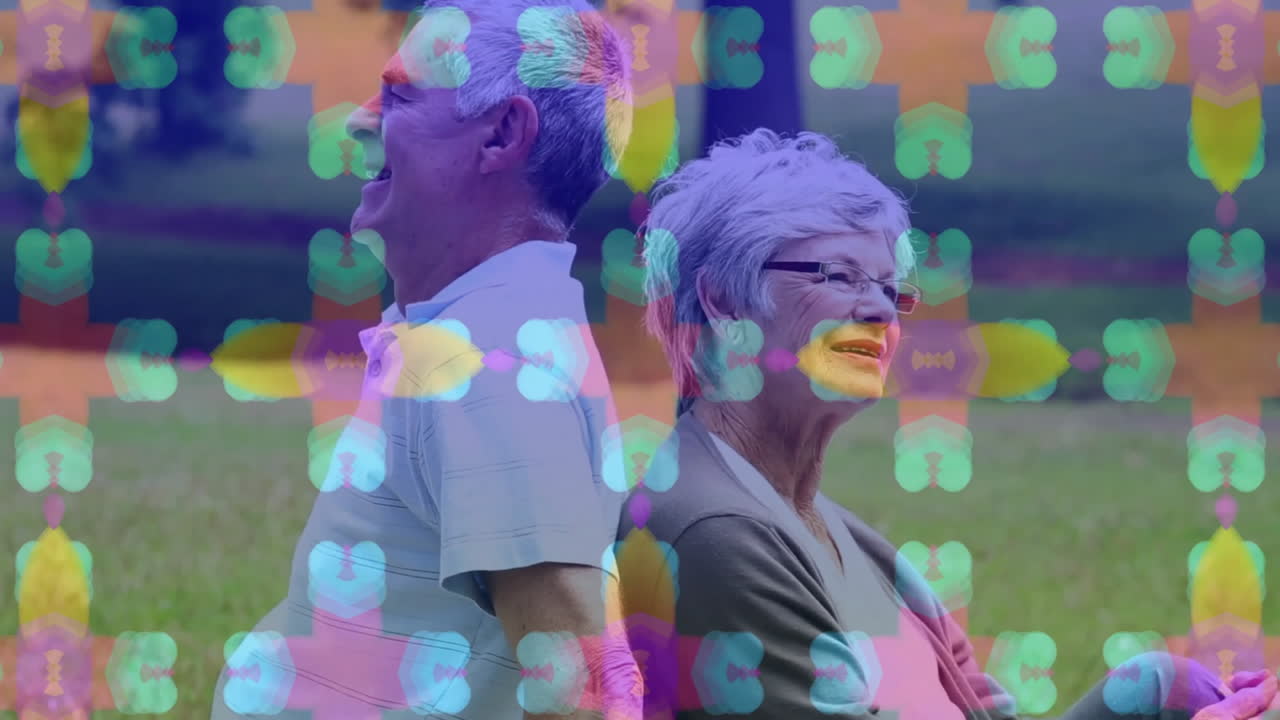 Standing back-to-back, elderly couple with colorful animation pattern overlay
