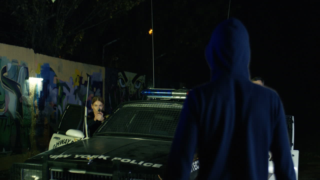 손을 들고 무릎을 꿇고 두건을 쓴 범죄자의 뒷모습