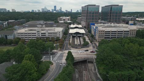 aerial approaching shot of lindbergh marta station wit atlanta downtown in background