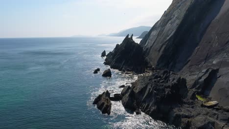 A-drone-shot-of-the-rugged-coastal-terrain-of-the-Dingle-Peninsula,-near-Dingle-Point,-in-Ireland