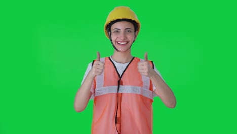 happy indian female construction worker doing thumbs up green screen