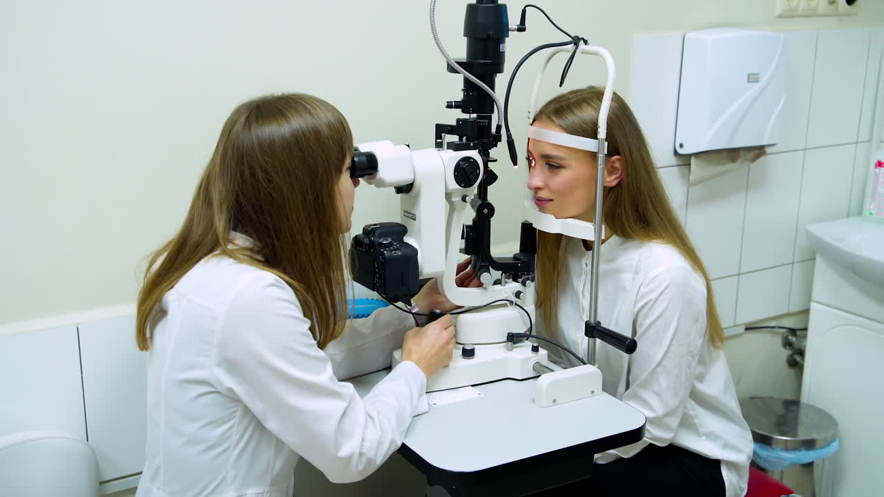 Woman visiting ophthalmologist. Doctor ophthalmologist examining eyesight of patient with special medical device
