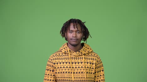 young handsome african man looking shocked