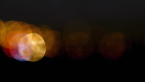 animation of glowing spots of light moving on black background