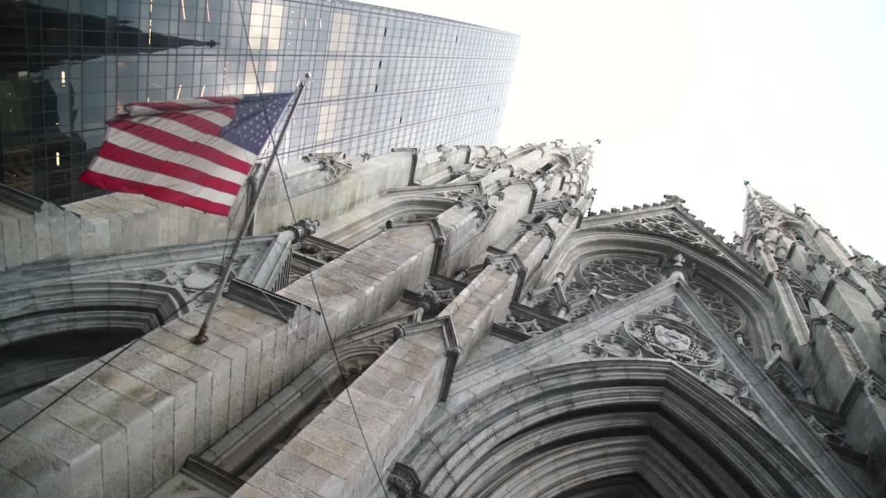 White and Old Church in the Middle of Manhattan with a Dusty USA American Flag Waving.