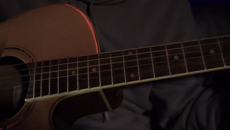 person playing an acoustic guitar