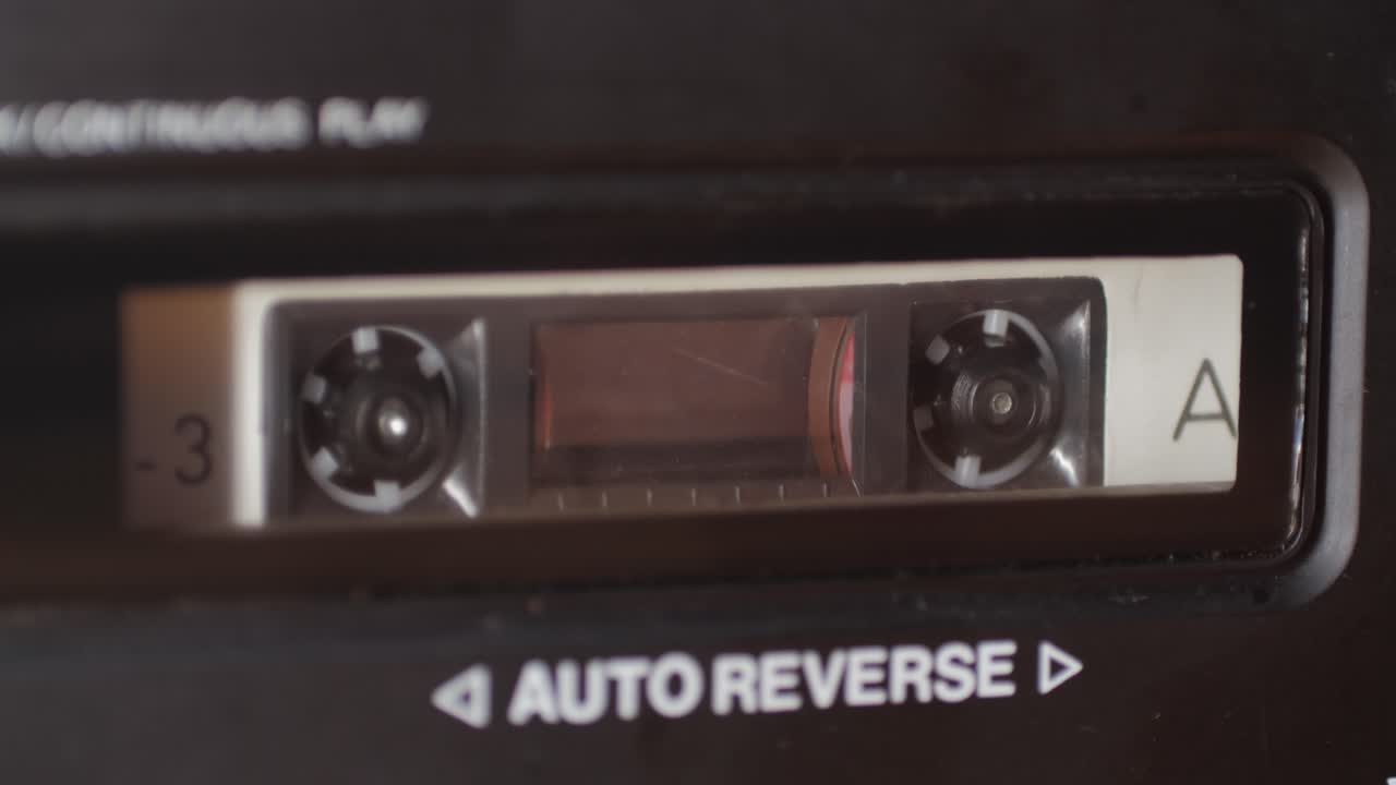 Retro radio tape recorder, audio cassette close-up. Listening to music, old radio boom box player, macro of vintage music listening.