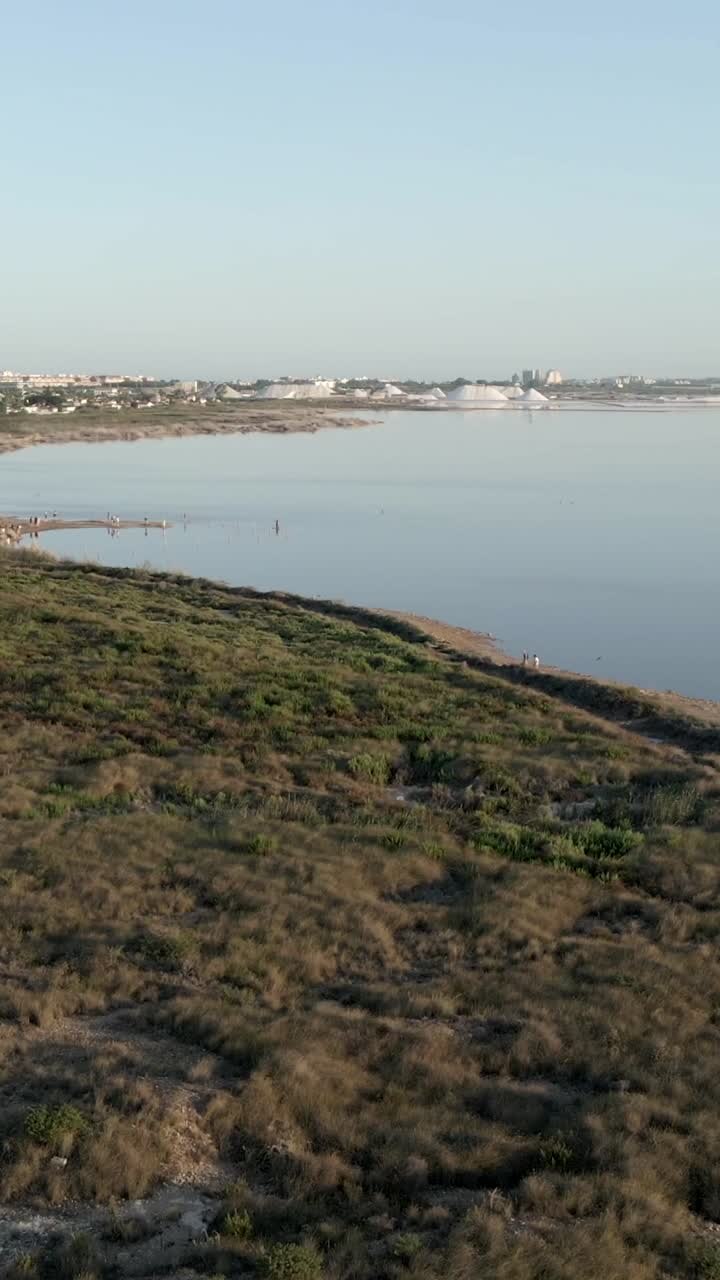 Salt Lake Landscape with Coastal Vegetation and People