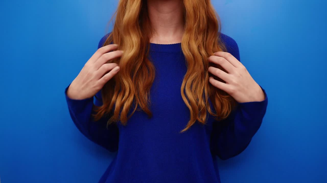 Beautiful Red Hair. Beauty woman shaking luxurious hair. Redhead model girl with Healthy Hair. Lady with long smooth shiny hair. Hairstyle, cure, extensions