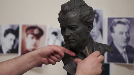 clay bust of a man in an artistic studio