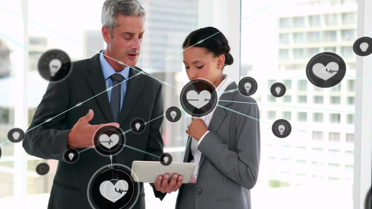 Two pros showing tablet and tapping, business heart and idea icons surrounding tablet for review