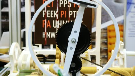 close-up view of plastic mechanism with rotating plastic gears. different working devices collection presented on the robotics forum exhibition