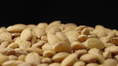 almonds falling onto a pile, close-up