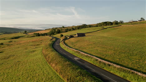 drone shot of yorkshire dales fields with quarry truck passing by