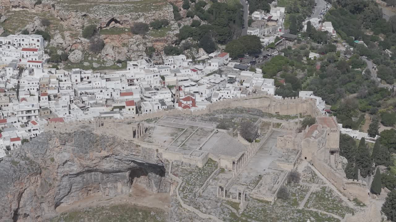 Premium aerial video showcasing the stunning natural landscape of Greece, Greece. The drone revelas the town of Lindos. 3x telephoto lens. D-Log M