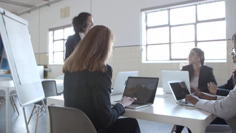 professional businesswoman making presentation to coworkers