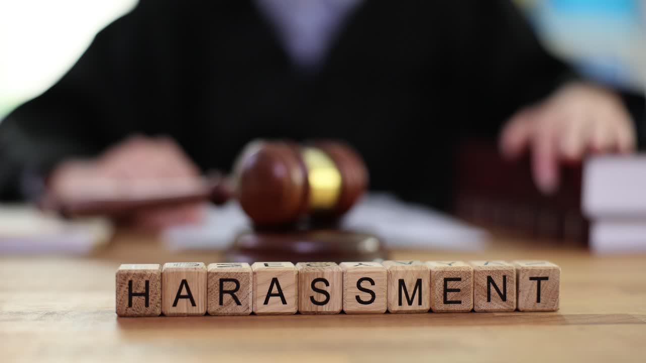Harassment concept with gavel and wooden blocks