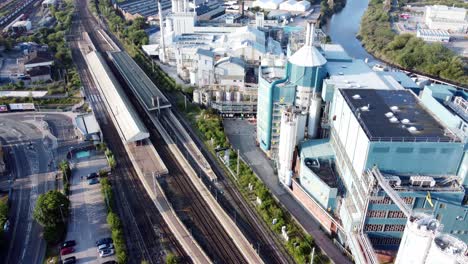 Industrial-chemical-manufacturing-factory-next-to-Warrington-Bank-Quay-train-tracks-aerial-view-slow-pull-back