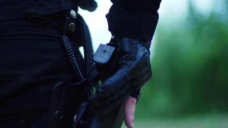 gloved operator fires pistol in slow motion with brass flying – tactical precision