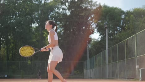 female tennis player practicing serve on outdoor court