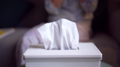 white paper tissue in a metal container box standing on a table outdoors in street sunny restaurant