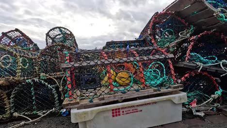 fishing traps and boats at a scottish pier