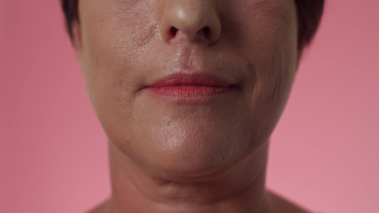 Middle-aged Woman Smiling against Pink Background