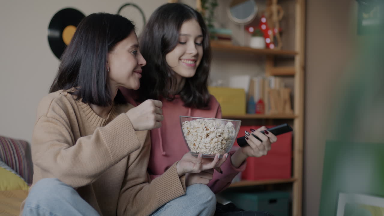 Sisters Watching a Movie and Eating Popcorn