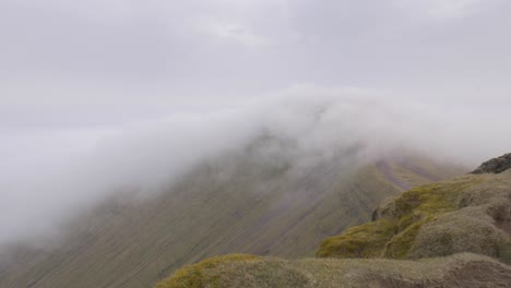 clouds and fog slowly rolling over pen y fan in brecon beacon hills, wales, uk 4k